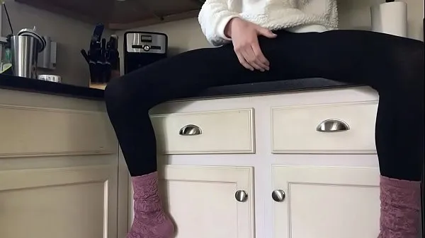 Grande Sissy in socks and leggings playing on the counter tubo total